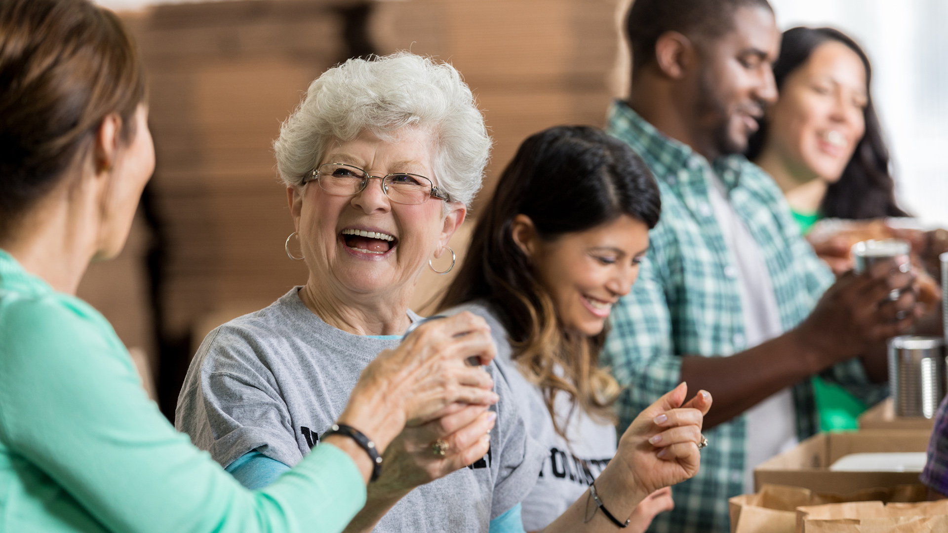 Beautiful cheerful senior woman volunteers at food bank Beautiful cheerful senior woman volunteers at food bank