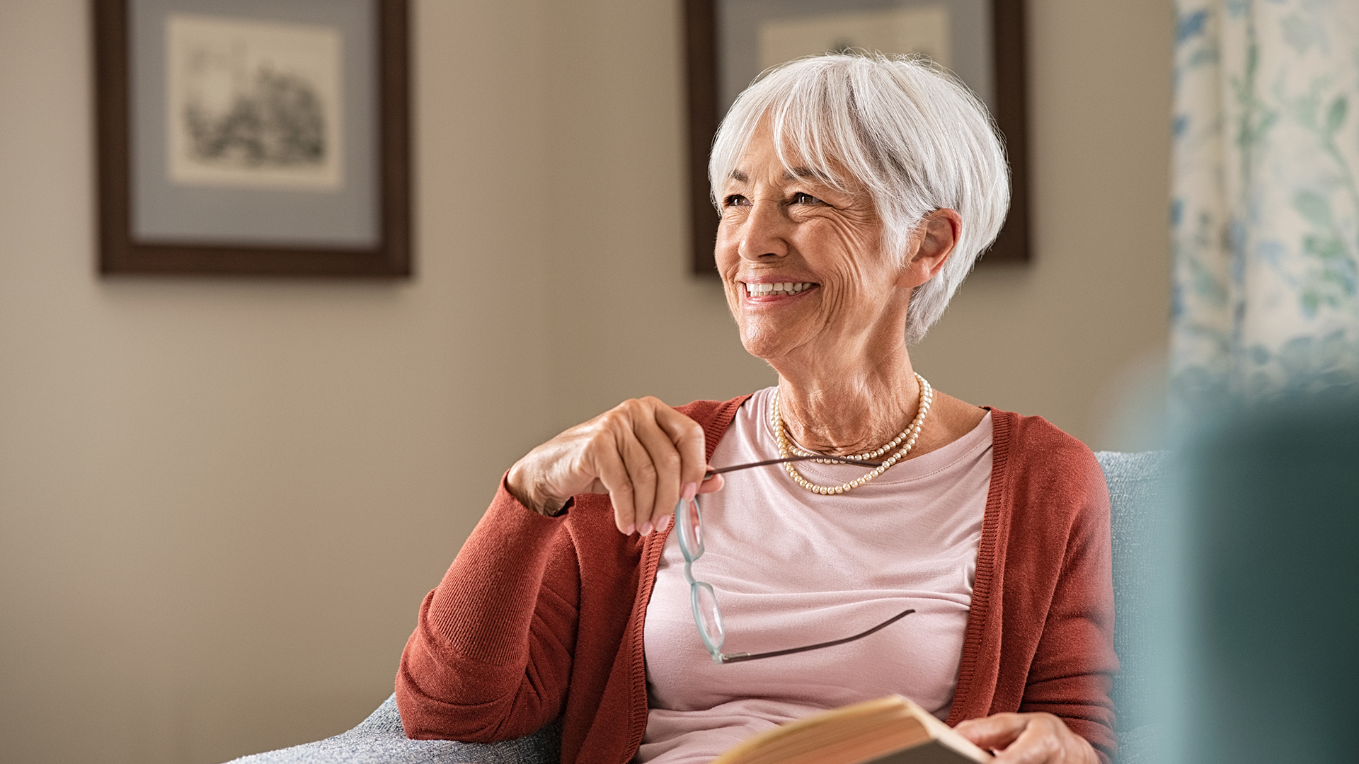 senior woman reading books on aging well at home